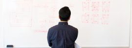 man standing in front of whiteboard